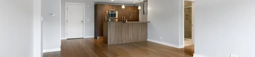 A room with wooden floors and white walls.