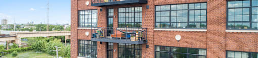a large brick building with many windows and fire escapes