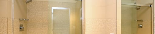 A bathroom with a sink, mirror, and shower.