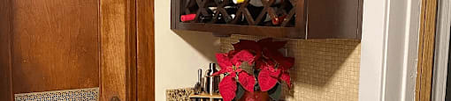 a wine cabinet in a corner of a room with a wine rack
