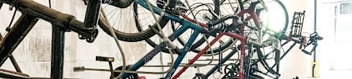 a row of bikes parked on a rack in a building