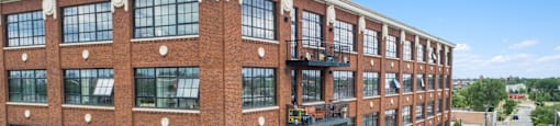 a large brick building with many windows and a street