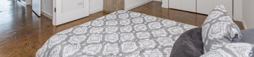 a bedroom with a large column in the middle of it and a bed with a