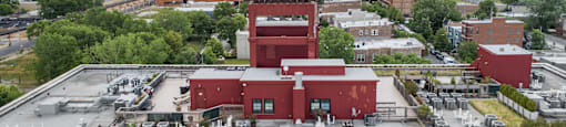 the roof of a factory with a city skyline in the background