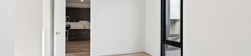 A room with a wooden floor and white walls.
