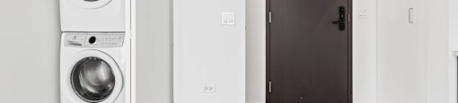A white washing machine and dryer in a small room.