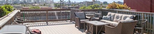 a roof deck with furniture and a view of the city