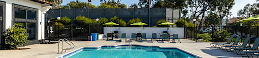 A large outdoor swimming pool with a diving board.
