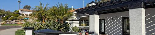 A house with a white fence and a small garden in front.
