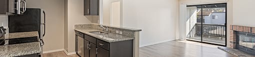 A kitchen with dark wood cabinets and a black stove top oven.