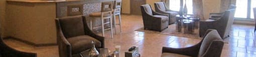 Clubhouse with brown chairs and a glass table at Forest Hill, 36618