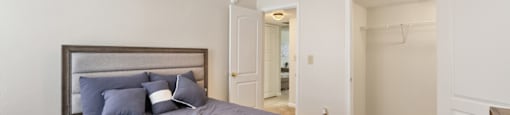 A bedroom with a bed, dresser, and mirror.