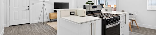 A modern kitchen with a stove top oven and a range hood.