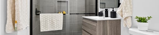 A modern bathroom with a walk-in shower and a white bathtub.