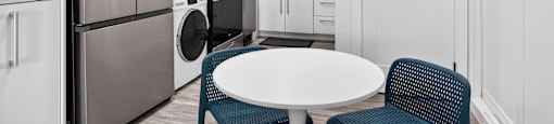A modern kitchen with a table and chairs.