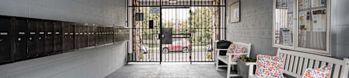 the lobby of a prison with benches and a gate