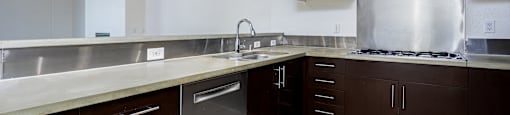 a large kitchen with stainless steel appliances and wood flooring