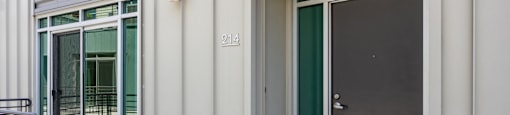the entrance to a building with two doors and a staircase