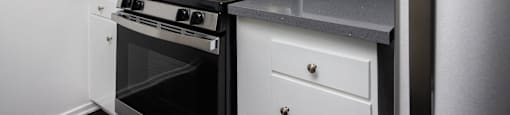 the preserve at ballantyne commons apartment kitchen with stove and refrigerator