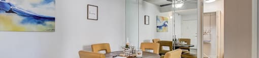 a dining room with a table and chairs and a ceiling fan