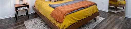 a bedroom with a yellow bed and a ceiling fan