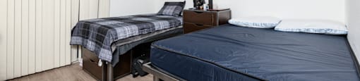 Furnished bedroom with bunk beds and desks