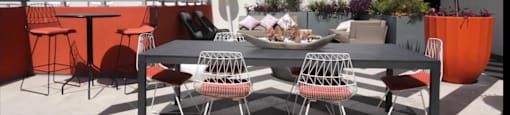 A table with chairs is set up outside on a patio.