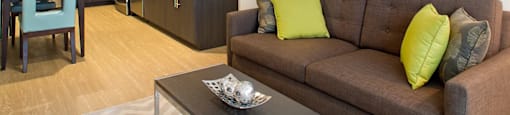 A modern living room with a brown couch and a coffee table.