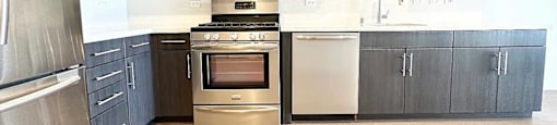 A kitchen with a stainless steel refrigerator and a stainless steel oven.