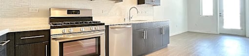A kitchen with a stove top oven, microwave, dishwasher, and refrigerator.
