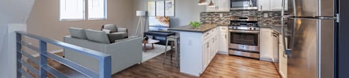 A modern kitchen with a refrigerator on the right side.
