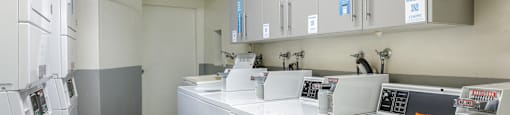 a laundry room with washers and dryers