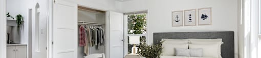 a bedroom with a bed and a table and a closet