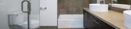 a bathroom with a toilet and a shower and a sink
