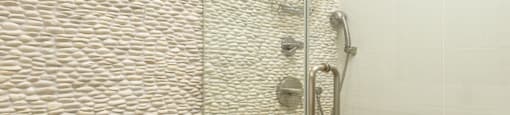 a large shower with a glass door in a bathroom