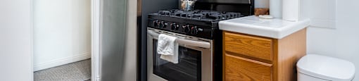 a kitchen with wooden cabinets and stainless steel appliances