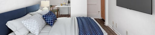 a bedroom with a bed and a tv
