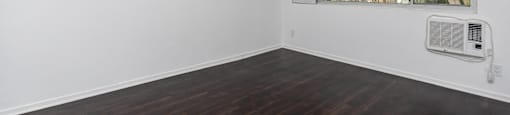 an empty room with white walls and a window