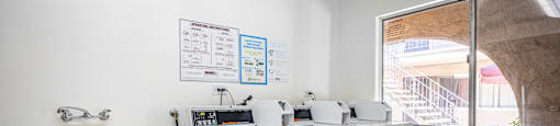 a laundry room with washing machines and a sink and a window