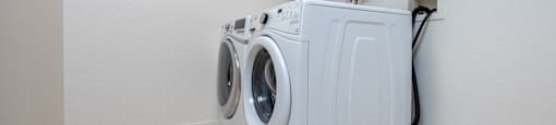 a washer and dryer in the laundry room of an apartment