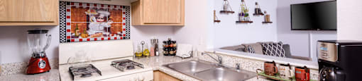 a kitchen with white appliances and granite counter tops