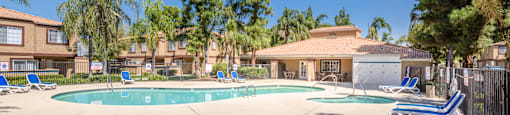 our apartments have a large swimming pool with chairs and trees