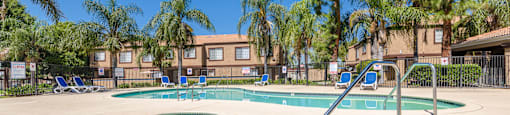 our apartments offer a resort style pool with chairs and trees