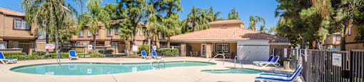 our apartments have a swimming pool with chairs and trees