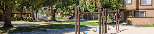 a playground in a park in front of a building