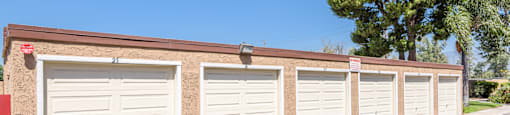 a row of garages at the side of a building