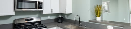 a kitchen with stainless steel appliances and white cabinets