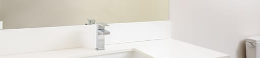 a white bathroom with a sink and a mirror