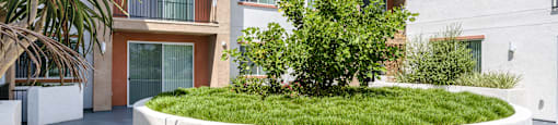 a large white planter in front of an apartment building