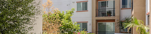 the courtyard atrium of an apartment building with plants and trees